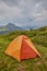 orange tourist tent in the mountains nature