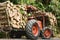 Orange tractor JCB or Truck loading wood in the forest