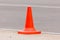 An orange traffic cone is placed on the edge of the racetrack