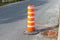 The orange traffic cone on the sidewalk in Montreal downtown