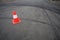 Orange traffic cone and skid marks
