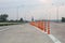 The orange traffic pole or flexible traffic bollard on asphalt road for crossroad