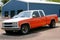 Orange truck american car parked