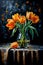 Orange tulips in a glass vase on a black background