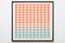 an orange and turquoise geometric pattern on a white wall