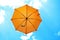 Orange umbrella flying on blue sky