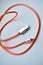 Orange usb cable with silver contacts on white background