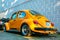 Orange Volkswagen Type 1 Beetle back low point of view, known some locally as a Kafer, Fusca and Bug