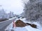 Orange warning cones and a utilities work zone, with crew and backhoe