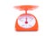 Orange weighing scales with pan and dial on white background kitchen equipment object isolated