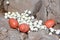 Orange and white plastic buoys on strong rope taken out of sea over winter and left on rocky beach