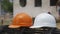 Orange and White Safety helmet (hard hat) for engineer, safety officer, or architect, place on Stainless Steel wire Roll