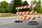 Orange and white striped road barricade, detour for street construction