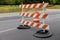 Orange and white striped three bar traffic barrier, road closed construction