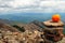 Orange on the wild stone heap on the mountain top