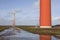 orange wind turbines on the dutch island of flevoland near Almere