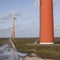 orange wind turbines on the dutch island of flevoland near Almere