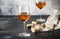 Orange wine in big wine glass, fashionable modern drink, gray counter background, copy space, selective focus