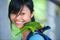 Orange-winged Amazon parrot perched on girl