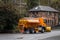 Orange winter maintenance gritter salt spreading lorry with snow plough fitted