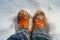 Orange winter shoes in snow