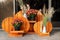 Orange wooden handmade craft halloween style flower-stand with chrysanthemum and dried herb flowers at house porch. Autumn