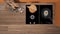 Orange and wooden kitchen close up, induction and gas hob with pot and fried egg in a pan. Vase with spikes, cutting boards. Top