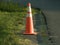 Orange work zone cone on side of road