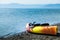 Orange and Yellow Kayak With Oars on the Sea Shore