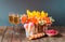 Orange and yellow lilies and white hydrangea flowers, glasses of champagne, cherry ice cream and fresh raspberry on wooden table