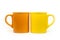 Orange and yellow mugs isolated