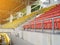 orange and yellow stadium grandstand seats with evening sunlight