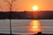 Orange and yellow sunset over frozen lake