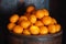 Oranges in a barrel dark background