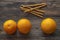 Oranges and bread sticks on a wooden board