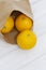 Oranges in a brown paper bag.  Environmentally friendly packaging concept