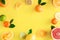 Oranges and citruses isolated on yellow background