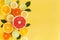 Oranges and citruses isolated on yellow background