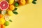 Oranges and citruses isolated on yellow background