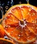 Oranges cut in half with water droplets on surface Close up macro photography of citrus Slices of Orange with splash of waterdrop