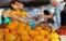 Oranges in the foreground and other fruit are sold at the weekly market.