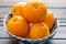 Oranges freshly picked off the three ready to be eaten on the kitchen table.