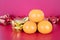 Oranges and gold ingots on flaming background.The Chinese characters in the picture mean `make more money`