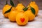 Oranges have a red heart-shaped put on the wooden table