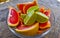 Oranges limes grapes lemon citrus grapefruit fruits on plate Mexico