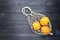 Oranges in natural hemp string bag on a dark wooden background. copy space