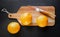 Oranges and old traditional pocket knife on a cutting board