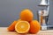 Oranges and slices with chrome citrus juicer