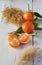 Oranges on white table with green leafs