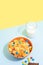 Oranhe bowl with tiny pancake cereal porridge with milk